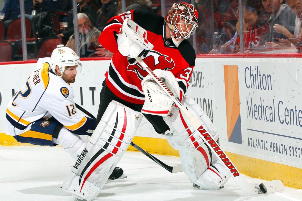 NEWARK, NJ - MARCH 03: Cory Schneider #35 of the New Jersey Devils plays the puck away from Mike Fisher #12 of the Nashville Predators during the game at the Prudential Center on March 3, 2015 in Newark, New Jersey. (Photo by Andy Marlin/NHLI via Getty Images)